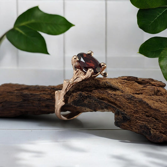 red garnet gemstone ring in a yellow gold setting