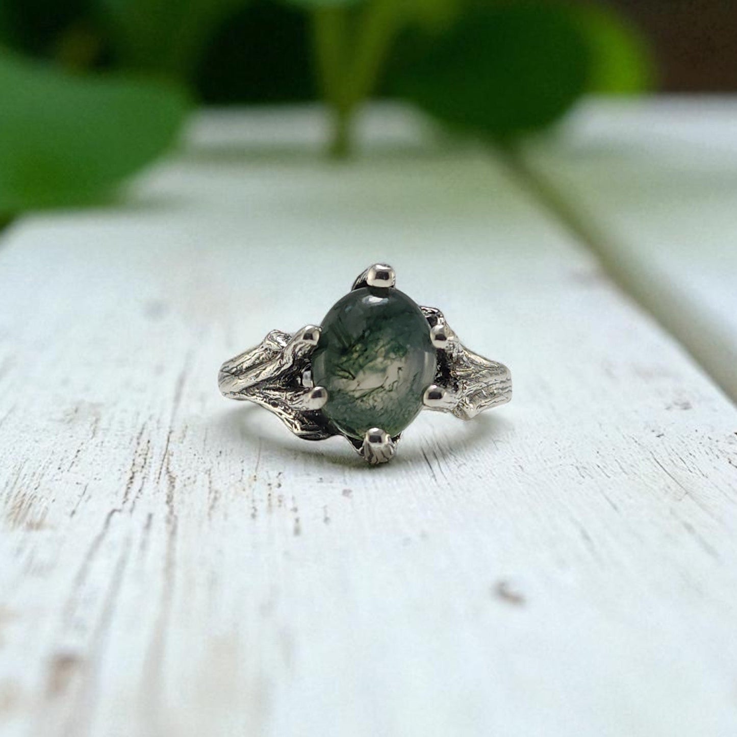Sterling Silver ring with prongs holding an oval moss agate ring