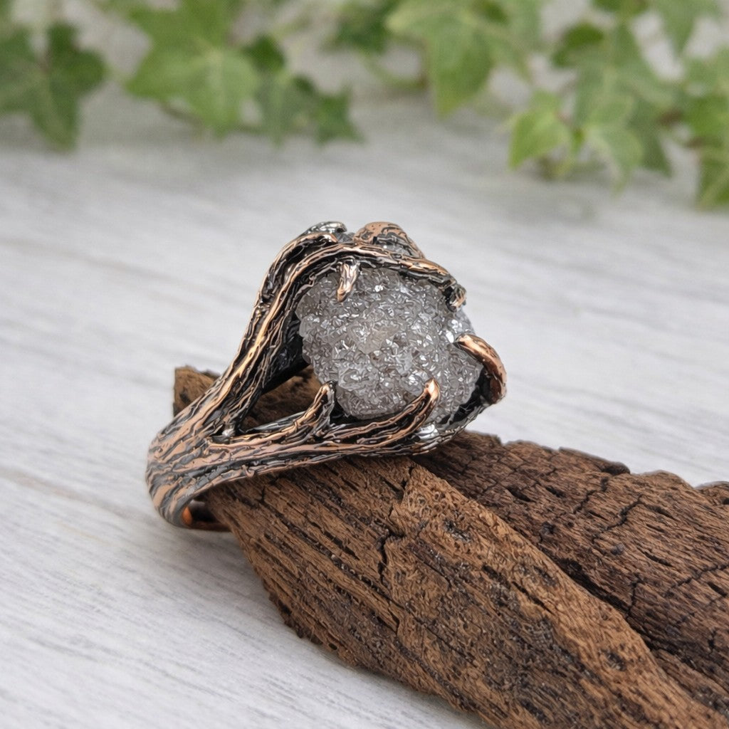 raw diamond twig engagement ring in rose gold on wood background