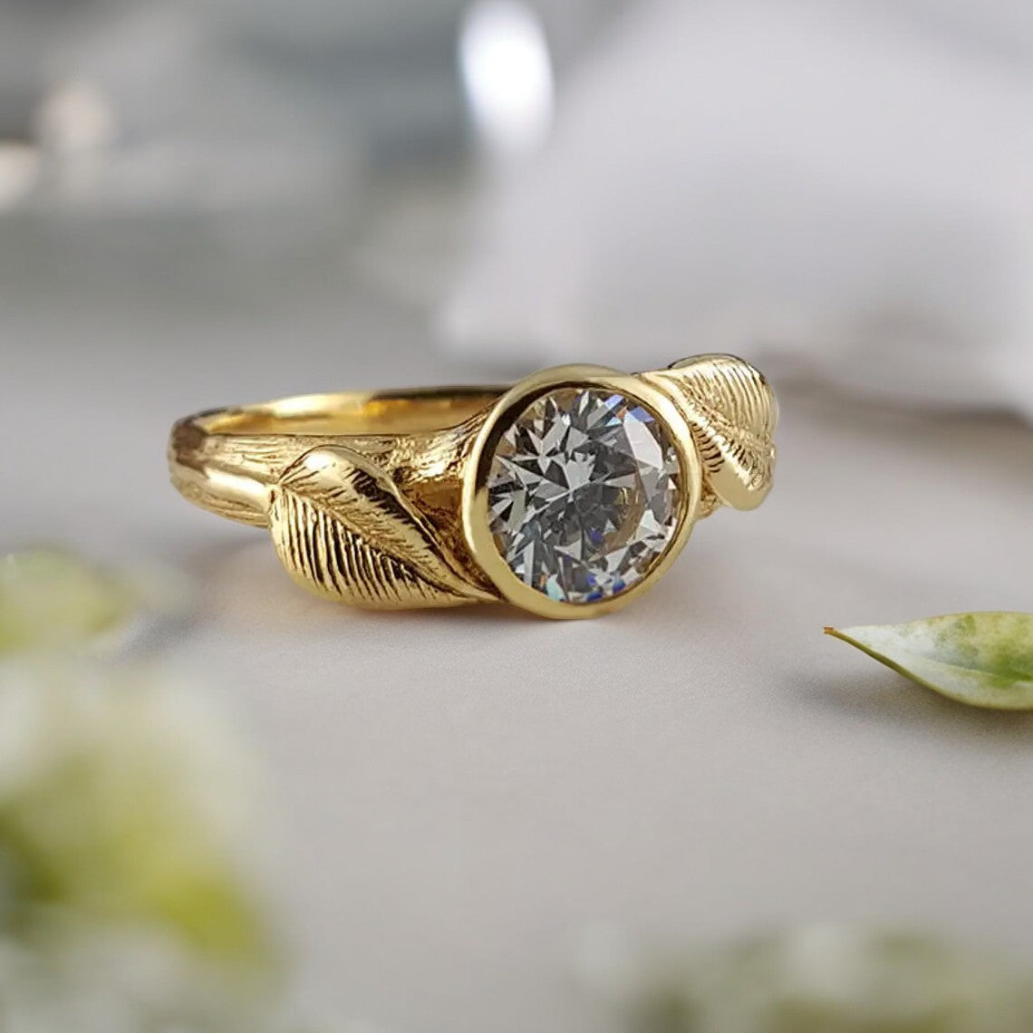 Gold ring with a round diamond with gold leaves around the stone