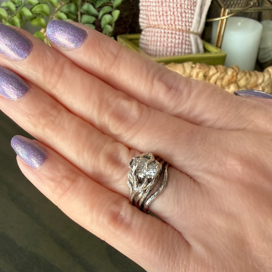 oval diamond twig style white gold ring on a hand
