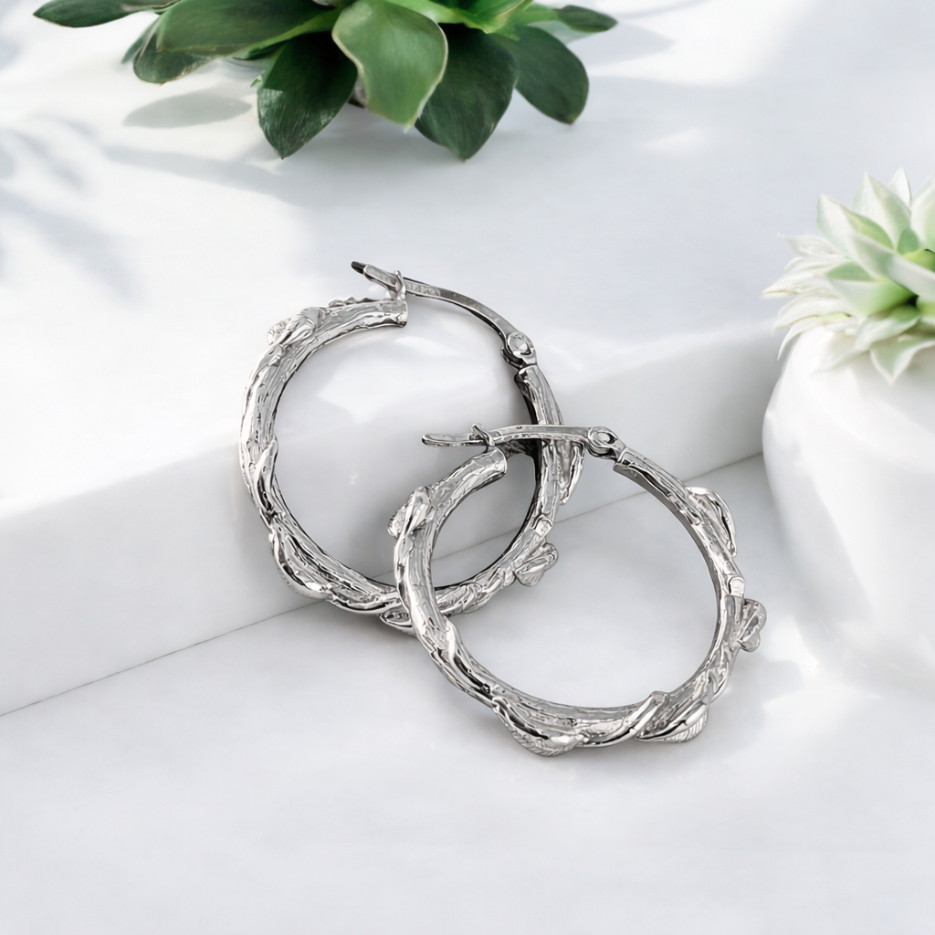 sterling silver hoop earrings with a delicate leaf designs all over