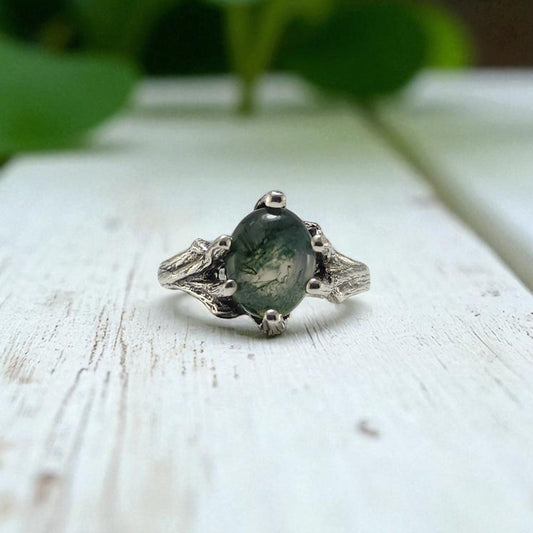 Sterling Silver ring with prongs holding an oval moss agate ring