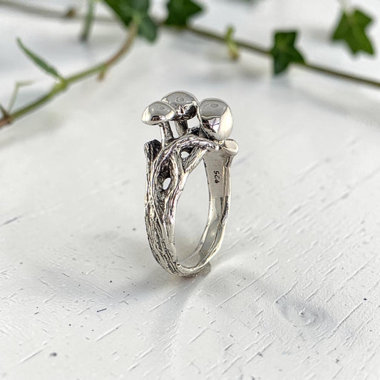 sterling silver ring with three mushrooms coming out of the top