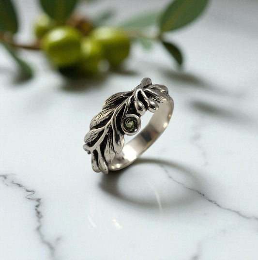 Olive branch and leaf sterling silver ring with a small round peridot stone in the center