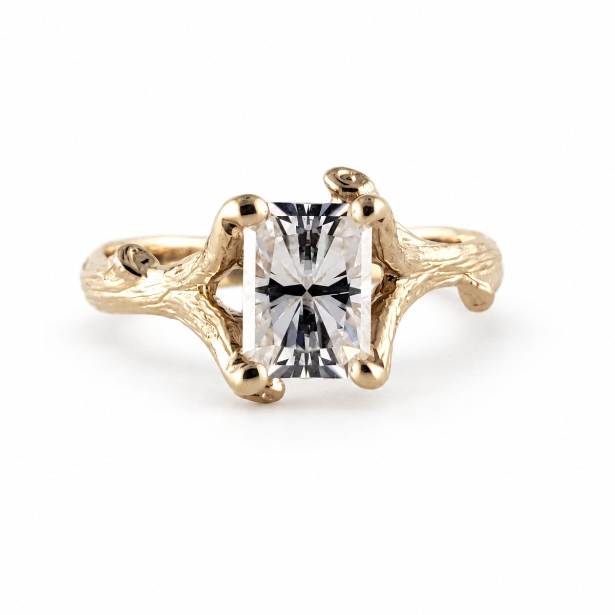radiant cut moissanite diamond in a twig branch setting in yellow gold