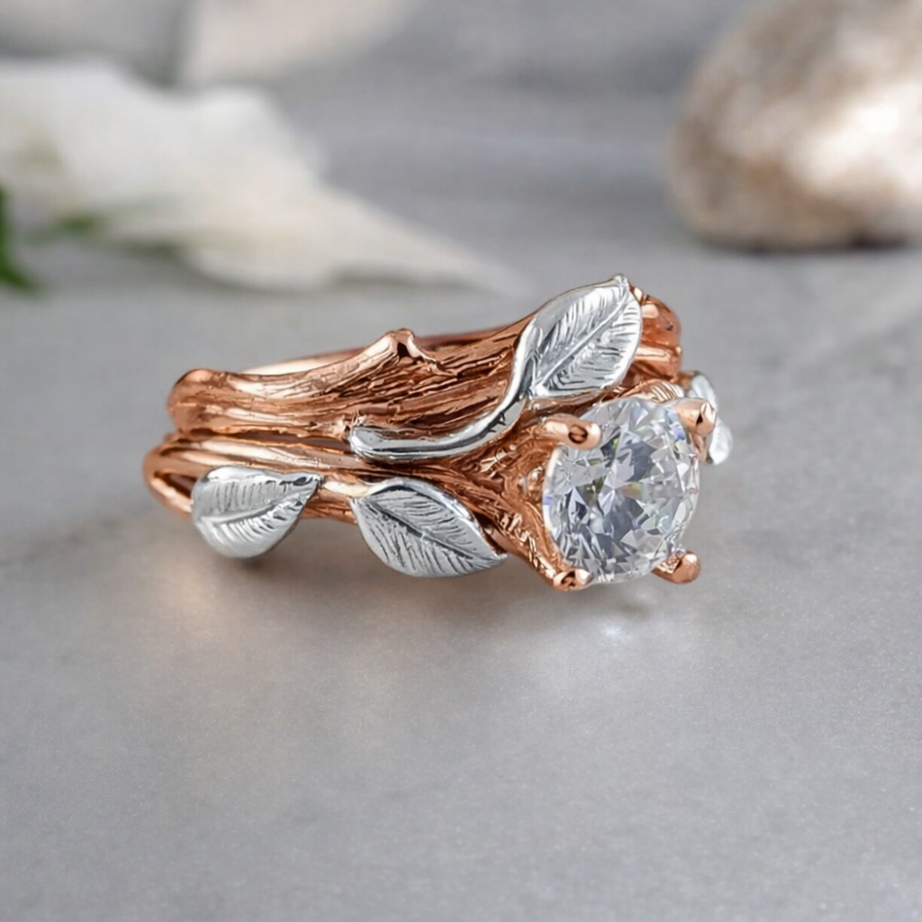 Rose gold and silver leaf design ring with a diamond on a light gray background